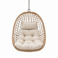 Silla colgante de ratán para exteriores con cojín beige